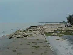 Damaged concrete seawall after a coastal storm in Florida