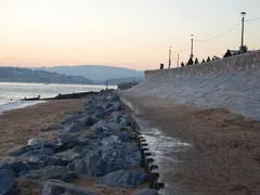 Concrete seawall protected by rock rip-rap at the waterline