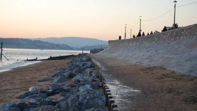 Concrete seawall protected by rock rip-rap at the waterline